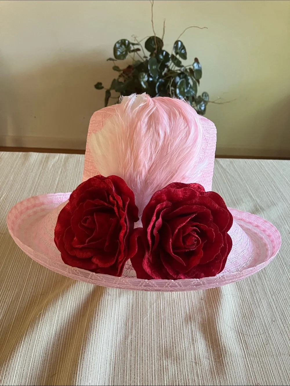 Chic Pink Wide-Brim Hat with Red Velvet Rose Detail and Feathered Accents